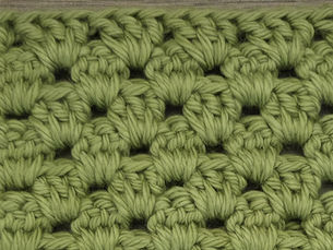 Close-up of yarn worked in Granny Stripe rows with groups of three Double Crochet stitch clusters