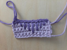 Lavender crochet swatch showing Spike Stitches worked into progressively lower rows.