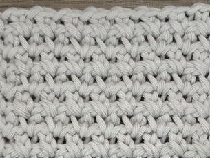 Close-up of yarn worked in the Pike Stitch with evenly space chain one openings.