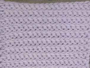 Close-up of lavender yarn worked in alternating front loop and back loop rows of Purl Slip Stitch.
