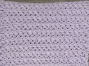Close-up of lavender yarn worked in alternating front loop and back loop rows of Purl Slip Stitch.