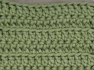 Close-up of yarn worked in rows of Front Loop Double Crochet Stitches