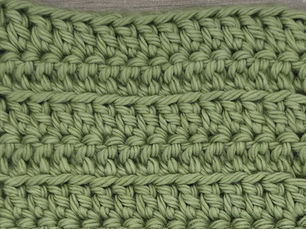 Close-up of yarn worked in rows of Front Loop Double Crochet Stitches