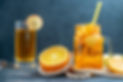 front-view-cocktail-cut-oranges-and-apples-on-wood-board-on-dark-isolated-background.jpg