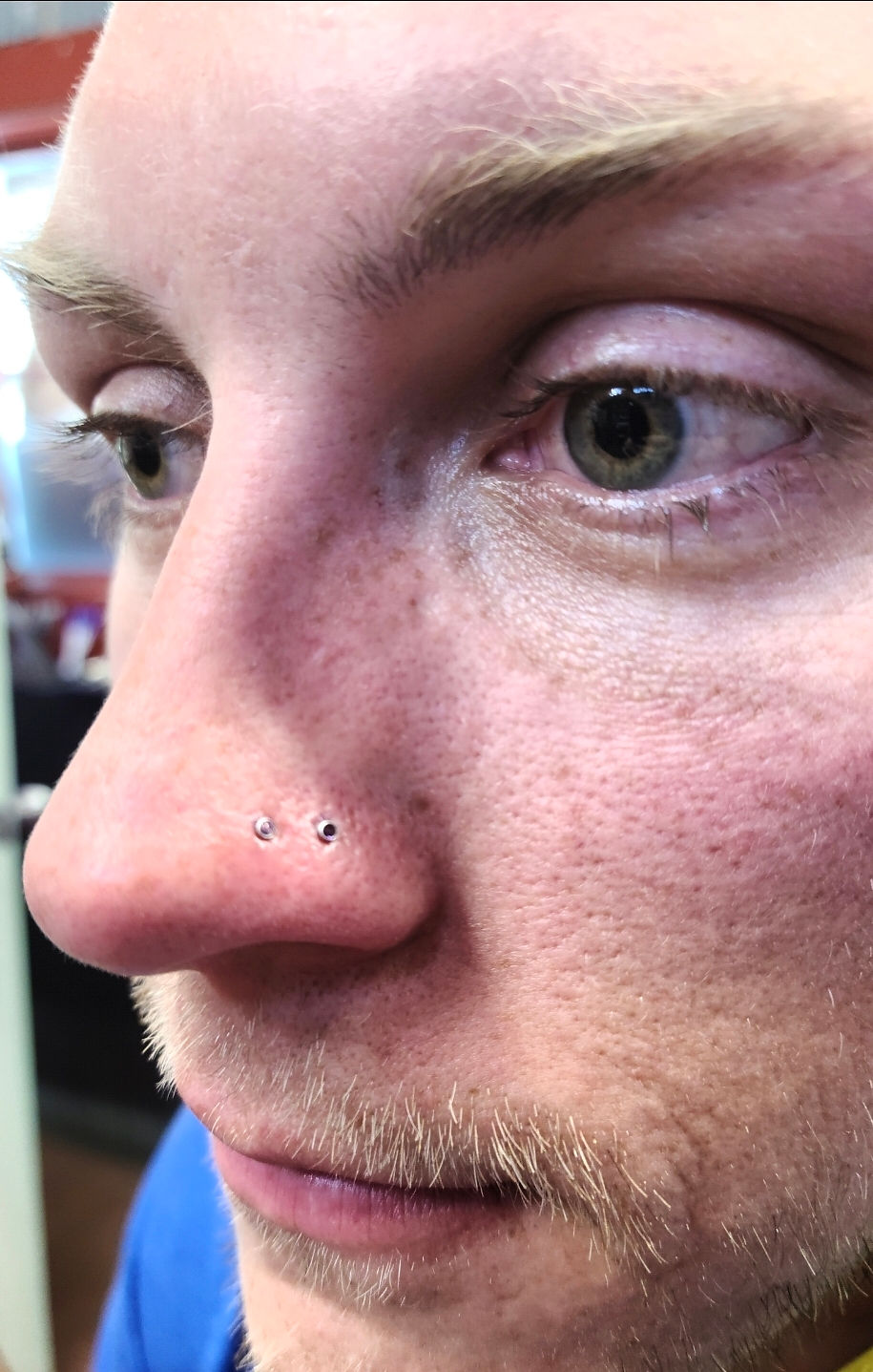 Staff member with double nose piercings