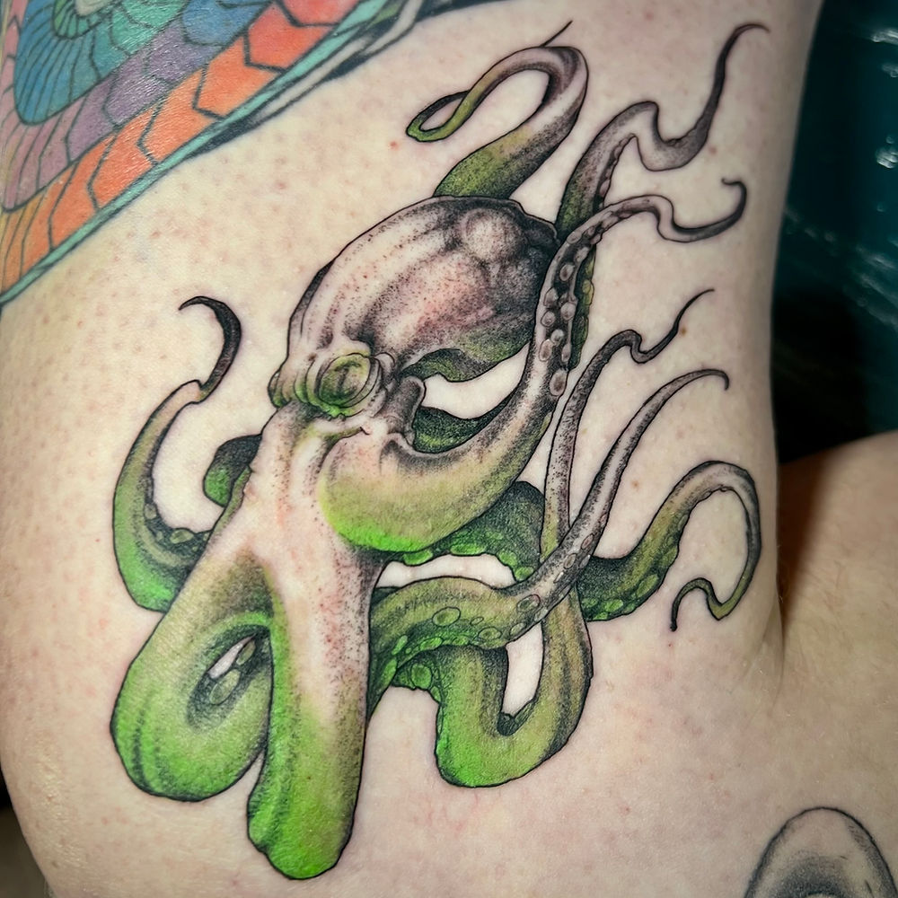 Detailed green and purple octopus tattoo