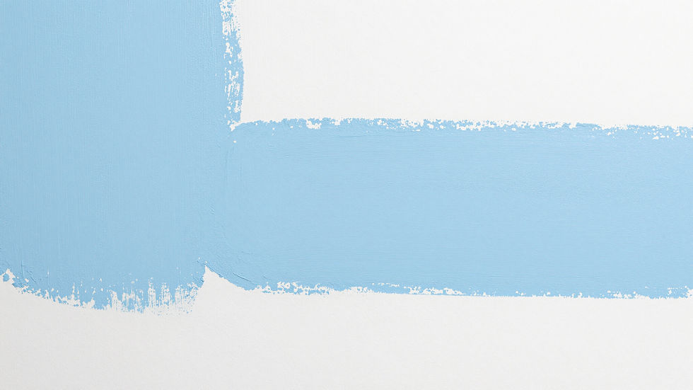 Light blue paint strokes on a white wall surface.
