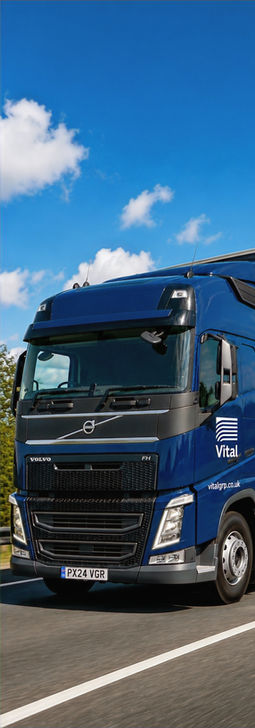Blue Volvo Vital semi-truck on road