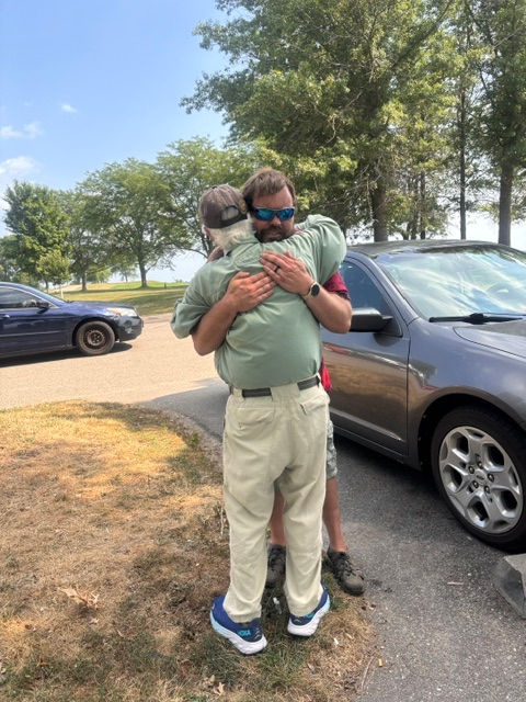 Teacher hugging Student