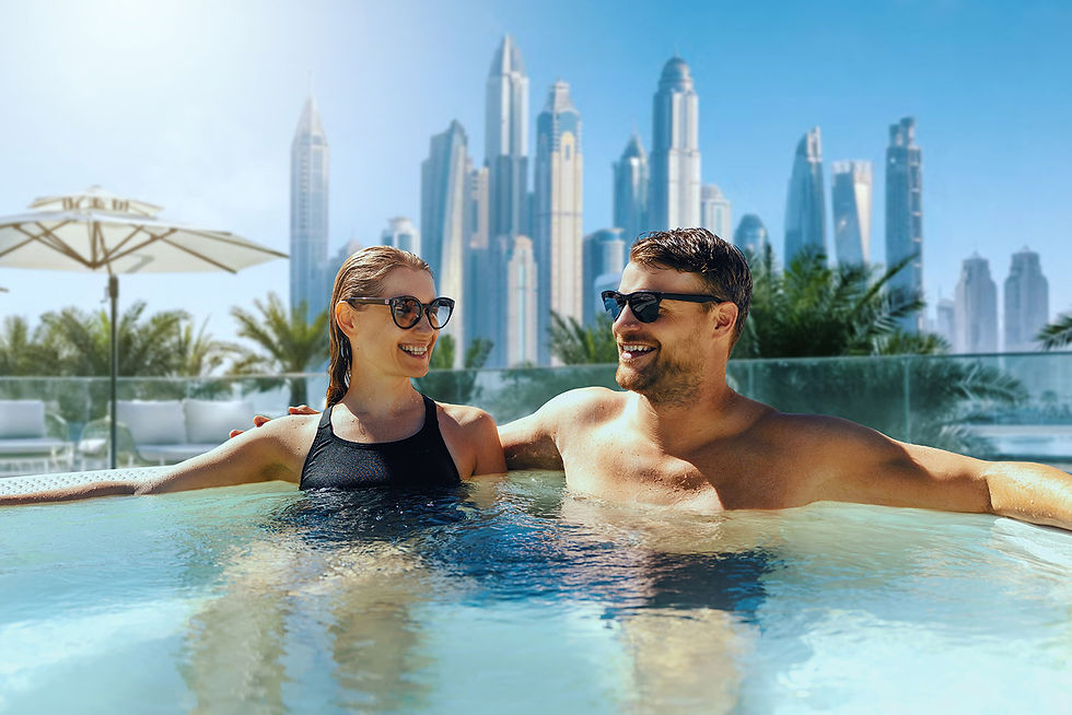 A relaxed couple enjoying a premium resort infinity swimming pool with the iconic, towering modern skyscrapers of the Dubai skyline in the background.