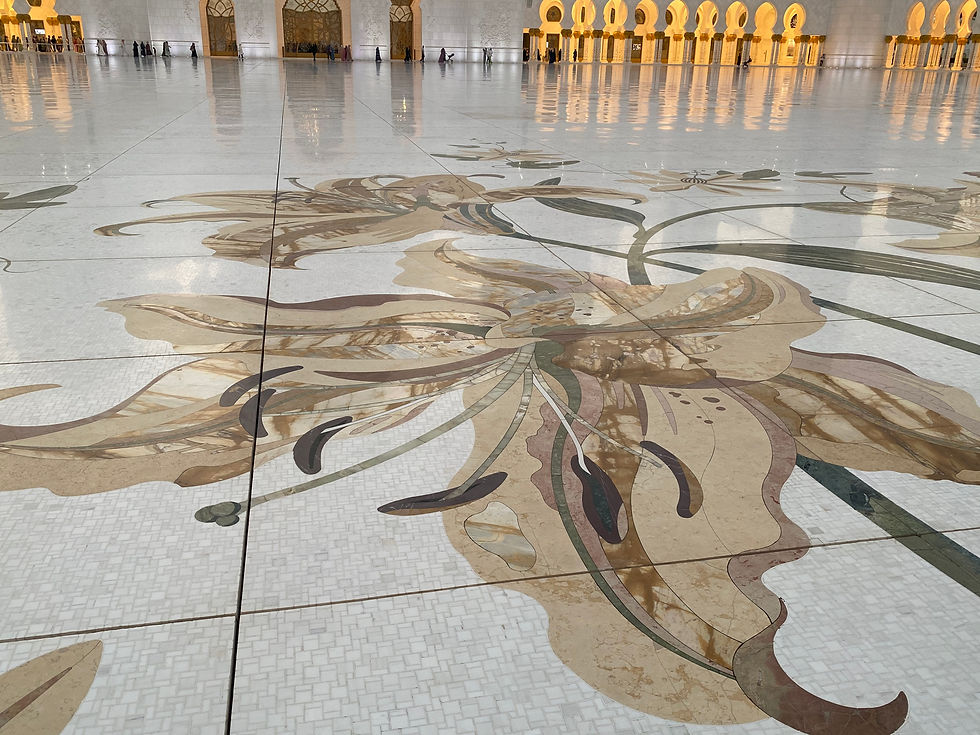 Intricate floral marble inlay artwork polished to a mirror shine on the massive courtyard floor of the Sheikh Zayed Grand Mosque in Abu Dhabi.