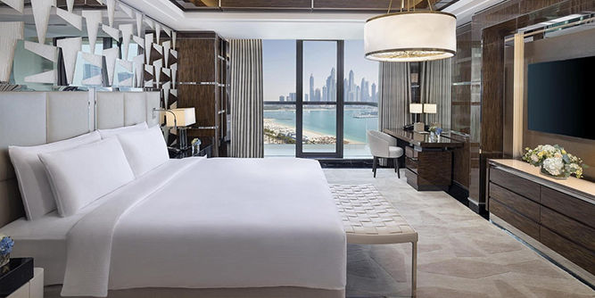 Massive family-friendly beachfront swimming pool running parallel to the West Beach oceanfront boardwalk at the Hilton Palm Jumeirah.