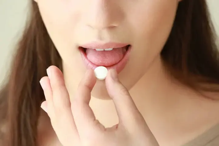 depositphotos_150298938-stock-photo-beautiful-young-woman-taking-pill.jpg