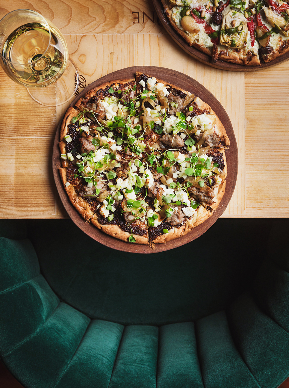 pizza on table with glass of wine