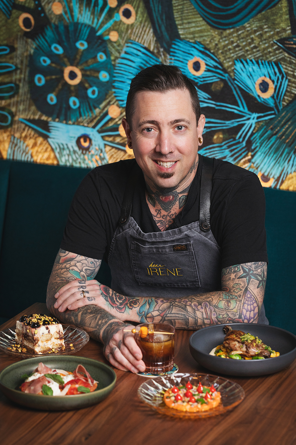 Chef sitting at table with food