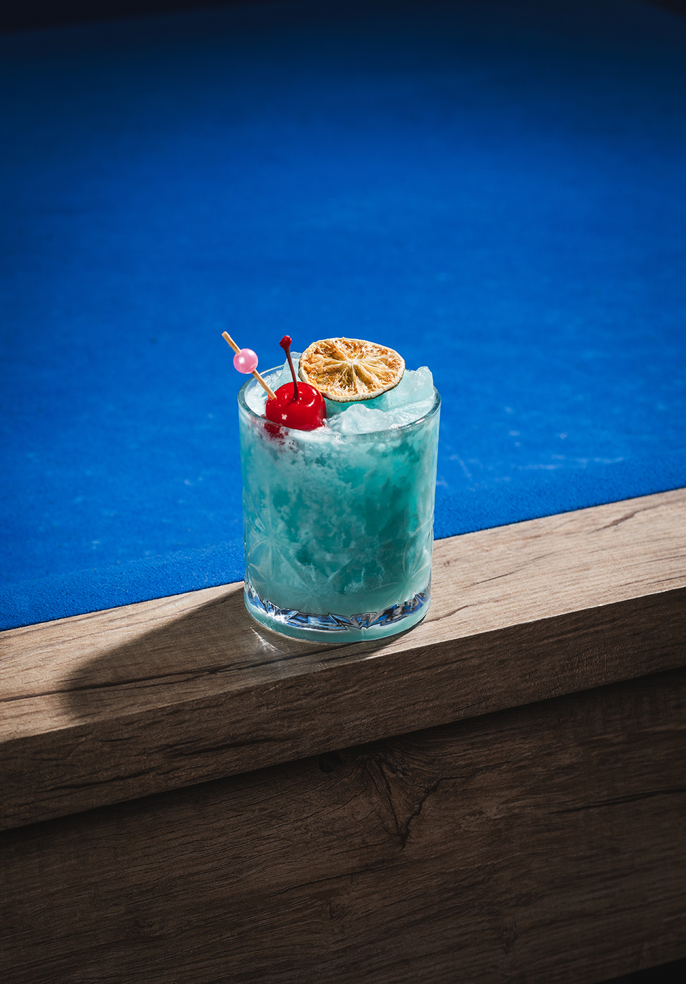 Blue cocktail on table