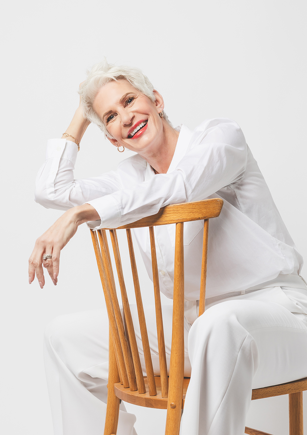 older woman with white hair sitting on chair