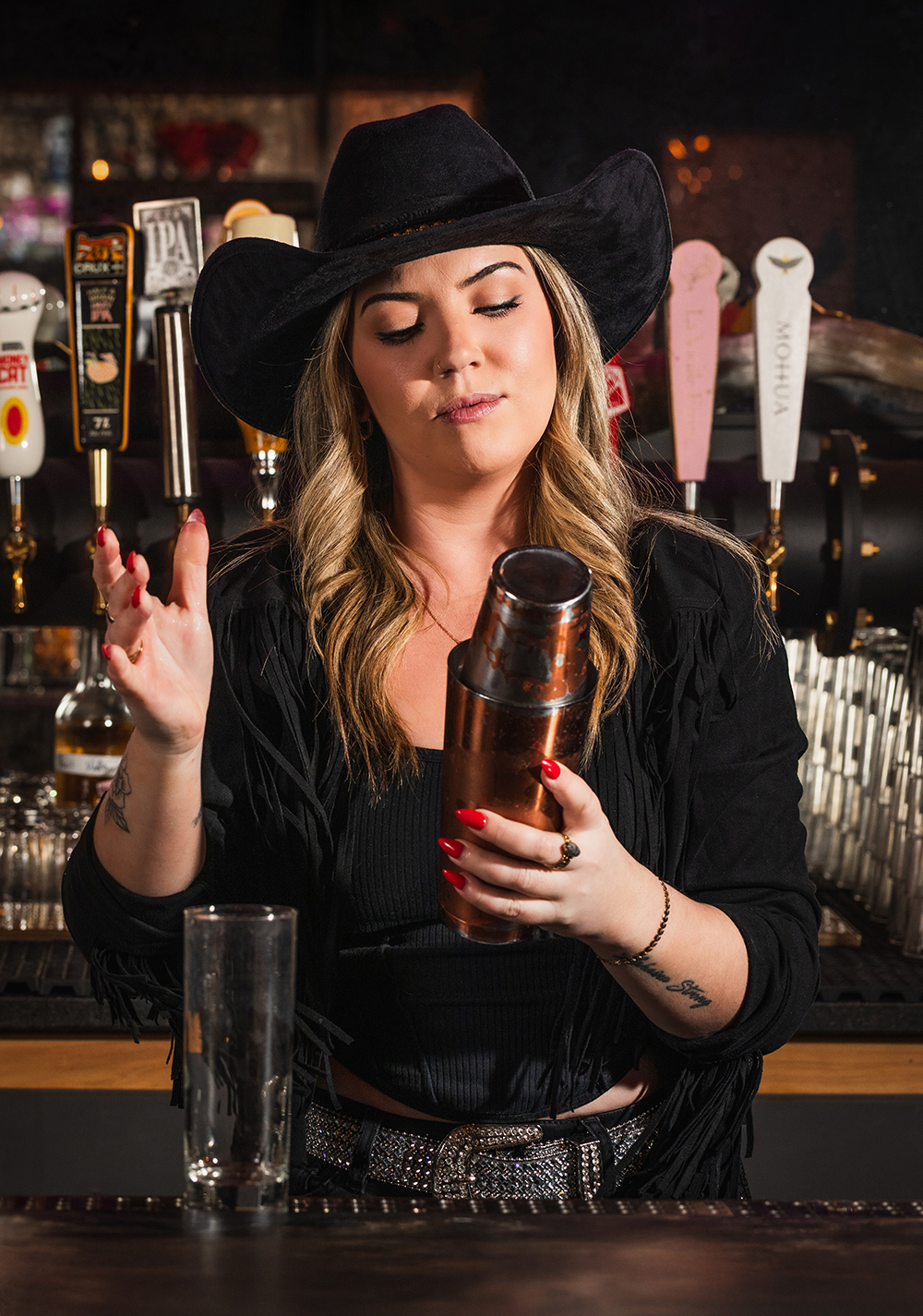 Female bartender with cowboy hat