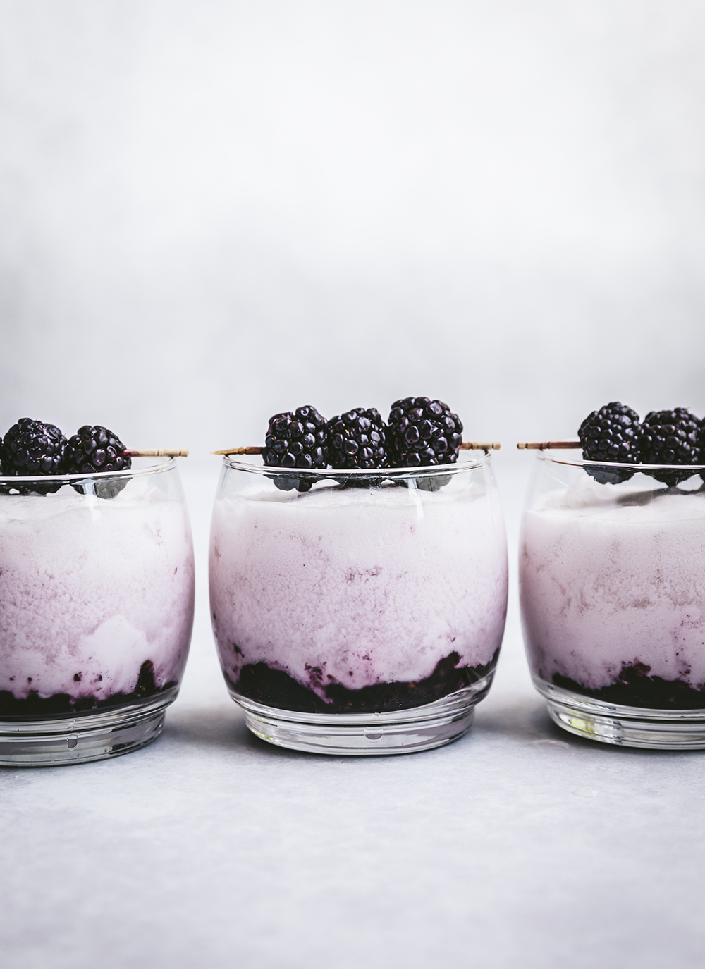 Creamy purple cocktails with blackberry garnish