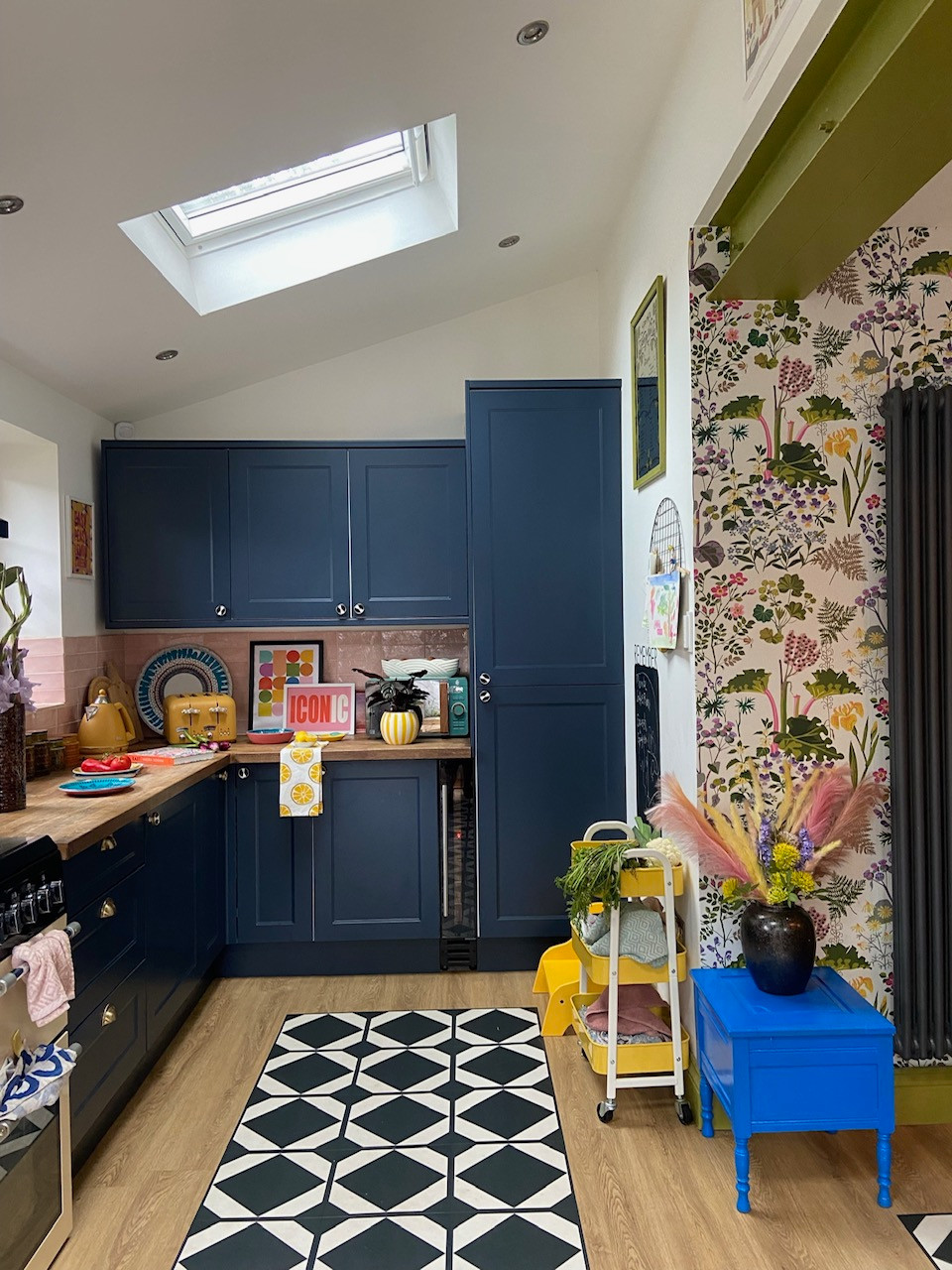 For a guaranteed pick-me-up, find some colourful wallpaper and create contrast by pairing it with a bold, complementary colour in the cabinetry. If you're feeling brave, you can inject further colour by picking ones from the wallpaper and sprinkling it in throughout various parts of the kitchen (for example, with the furniture, decor or backsplash). A clever way to avoid colour-overload is to keep a portion of the walls and flooring white or neutral — just like how Interior Design Guru, Laura, has done in her kitchen pictured above.