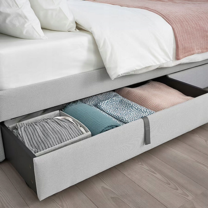 A prime location is the space under the bed. Use rolling storage containers to store items such as blankets, throws, and perhaps even wrapping paper under your bed. This will keep them out of sight and free up space in the bedroom.