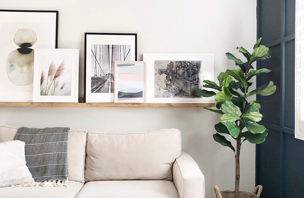 Framed photos and art are great items to begin with. No matter how big or small they are, pieces of artwork or photographs of special memories beautifully add a punch of character and personality to the shelf. Ideally, you could lean them against the wall — one of the many compositions of gallery walls. Choose your favourite artwork pieces, create a focal point, and build the rest of the decor around them. Don’t forget to consider the height between the shelves and choose frames that fit the space. You would also want to think about your colour palette to decide which frames would work best with the decor.