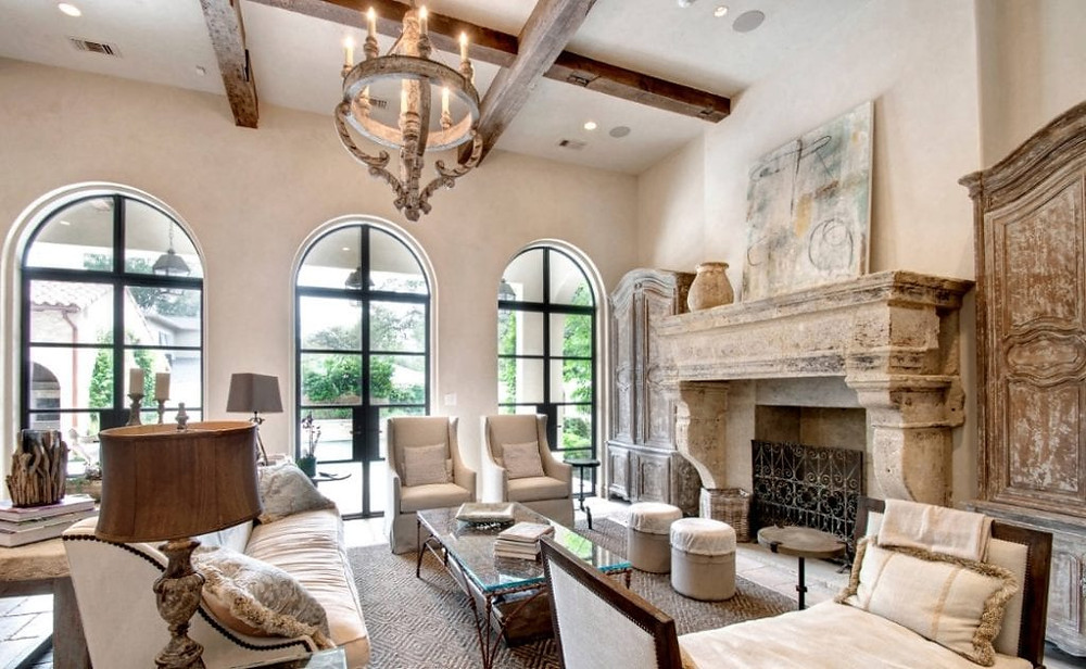 Natural materials with weathered appearances make a statement in French Country. Wood-beamed ceilings, planked floors, and stone fireplaces can be commonly found in this design style. The lighting should have a distressed appearance, as you’d find in rustic decor. Think rustic chandeliers and metallic Candelabra light bulbs.
