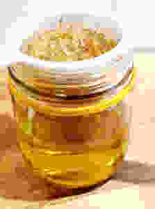 straining flowers out of infused oil