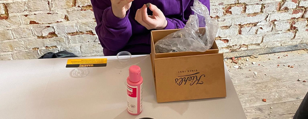 A Scout examines the owl pellet they're holding