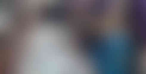 Squirrel and Beaver Scouts stand along a table mixing chocolate and biscuits together in bowls