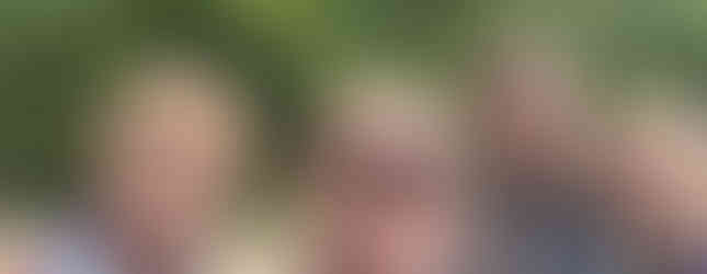 Three Squirrel Scouts pose for a selfie with their leader who's taking the photo