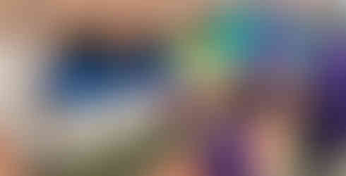 A Squirrel Scout and a Leader go head to head throwing tennis balls into large buckets