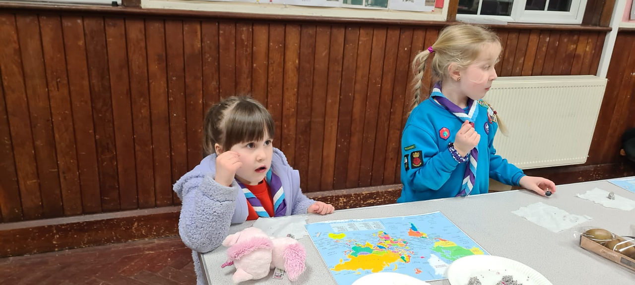 A Squirrel and a Beaver Scout look at maps