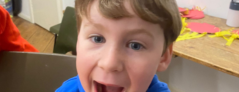 A Squirrel Scout shows a face of excitement with an open mouthed wide smile