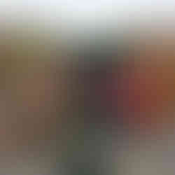 A Squirrel Scouts sits on the firing seat of a WWI 18pr gun. On his right are soldiers in WWI uniform and on his left are a soldier in WWI uniform and a woman in WWI era civilian dress