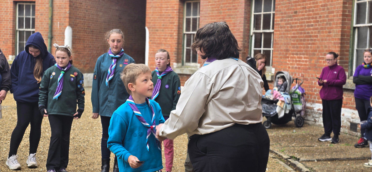 A Beaver shakes left hands with his leader