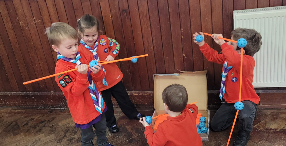 Squirrel Scouts use poles and waffle balls to build structures