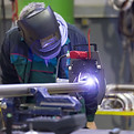 Industrial operator setting computer controlled process of orbital welding machine in ino