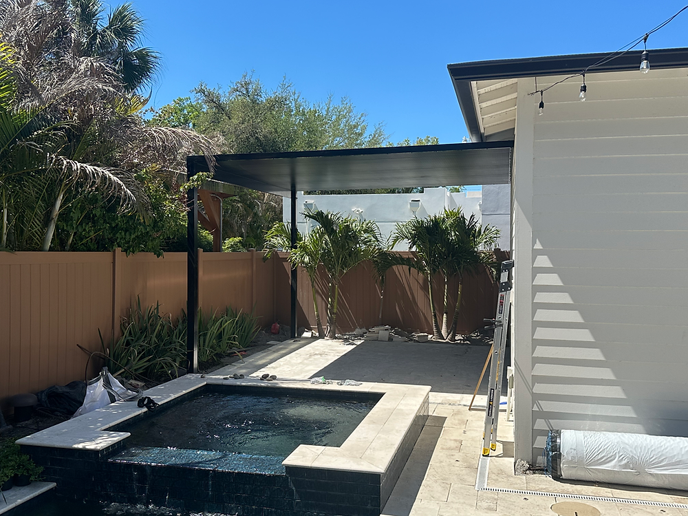 Modern backyard with pool, patio, and brown privacy fence