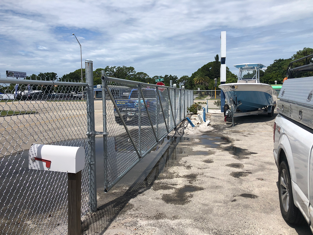 Rolling Chain Link Fence gate at facility with boat