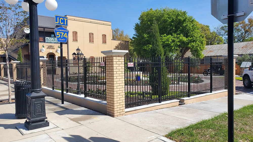 Wrought iron fence enclosing a landscaped corner