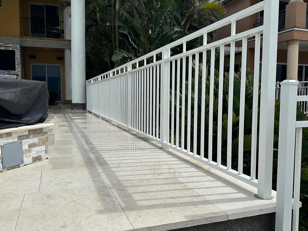 Modern white railing on a tiled patio