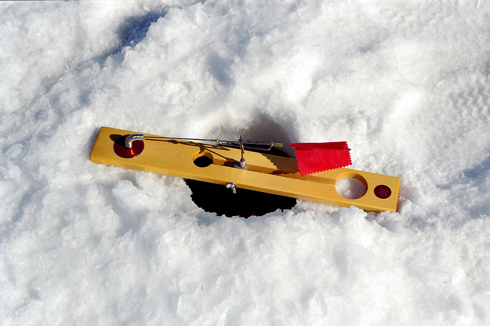 Tip up board over an ice fishing hole