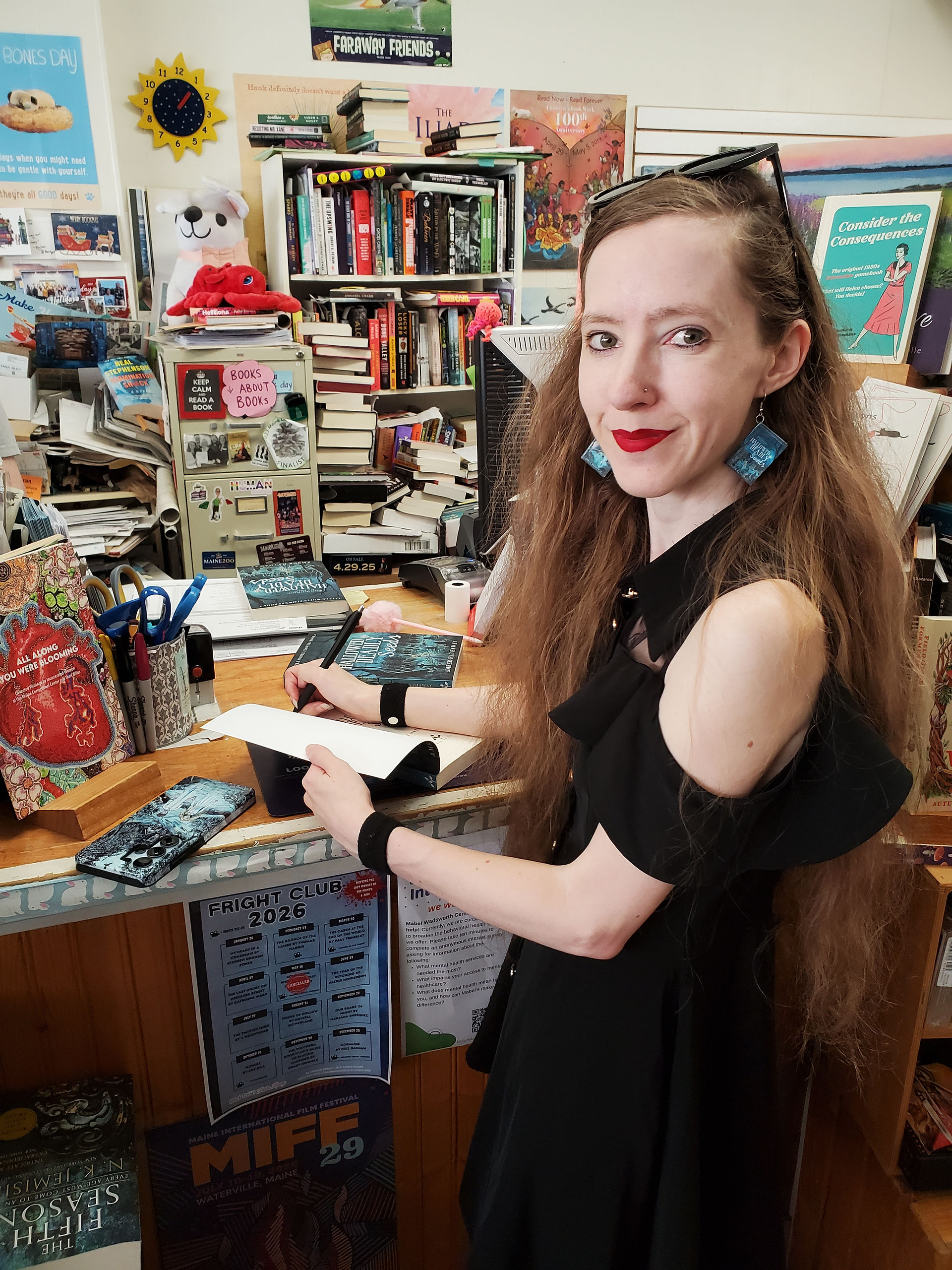 Amber signing copies of Hallowed Deadly Seeds at The Briar Patch.
