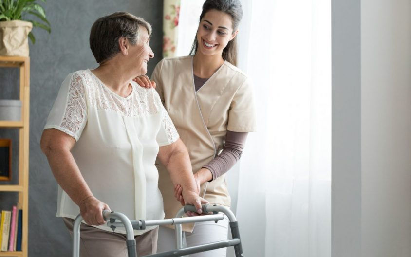 physio with a person with a walker