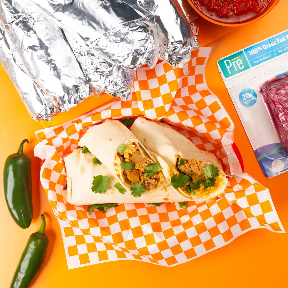 An overhead shot of pile of burritos and Pre ground beef 