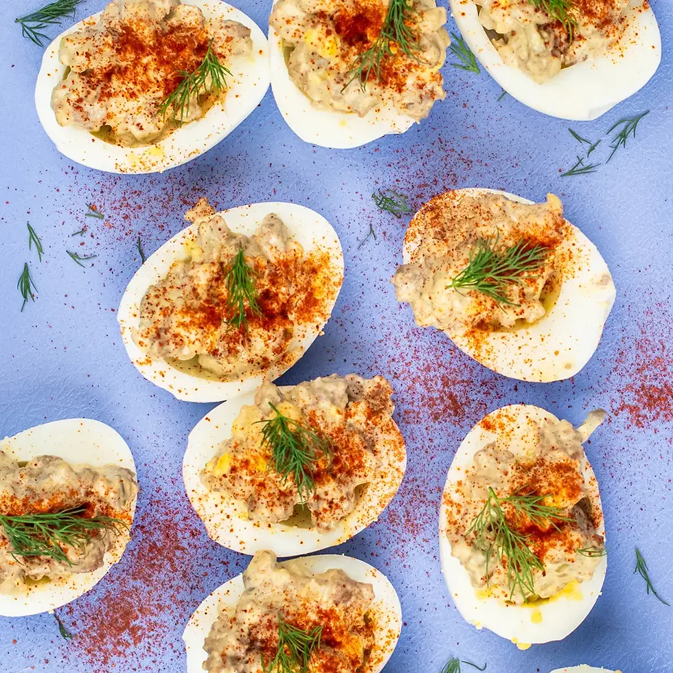 An overhead view of deviled eggs on a cutting board.