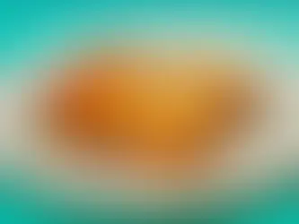 A big square piece of lasagna with ground beef and cheese on a plate.