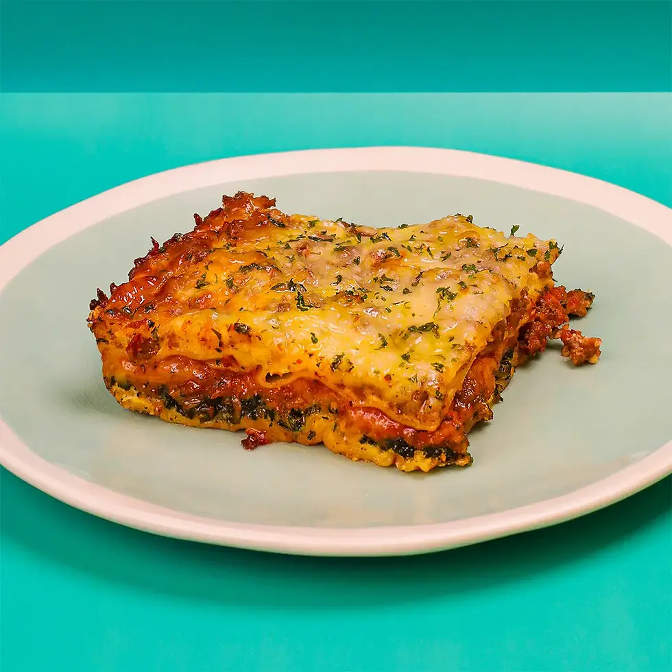 A big square piece of lasagna with ground beef and cheese on a plate.