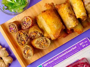 A platter of egg rolls and sauce with a package of Pre 95% Lean Ground Beef.